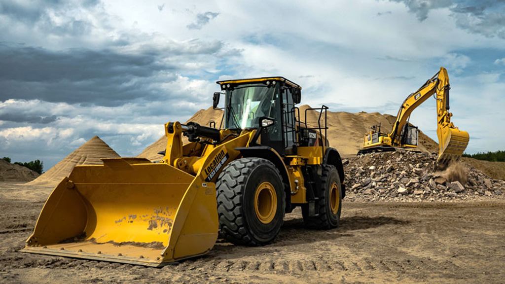 photo of construction vehicles, outdoors, cloudy skies