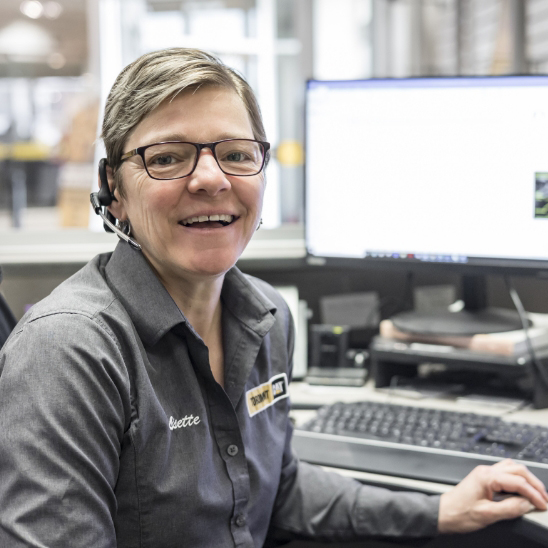 woman sitting in front of desk, smiling