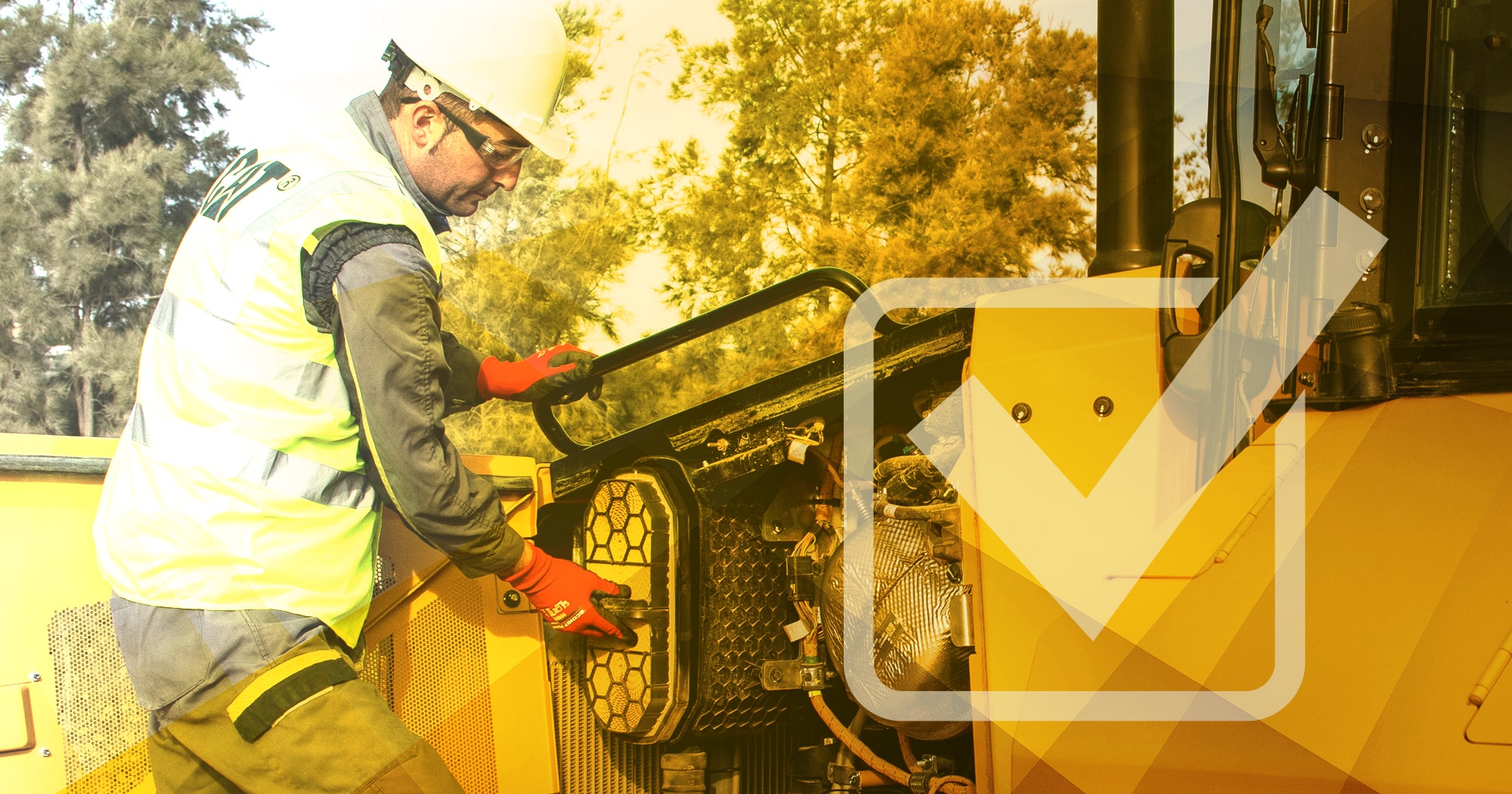 A construction worker maintaining machinery